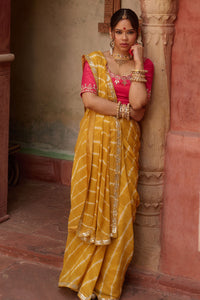 Kanak – Mustard Yellow Leheriya Saree and Rani Pink Blouse