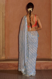Neelima – Sky Blue Leheriya Saree with Orange Sleeveless  Blouse