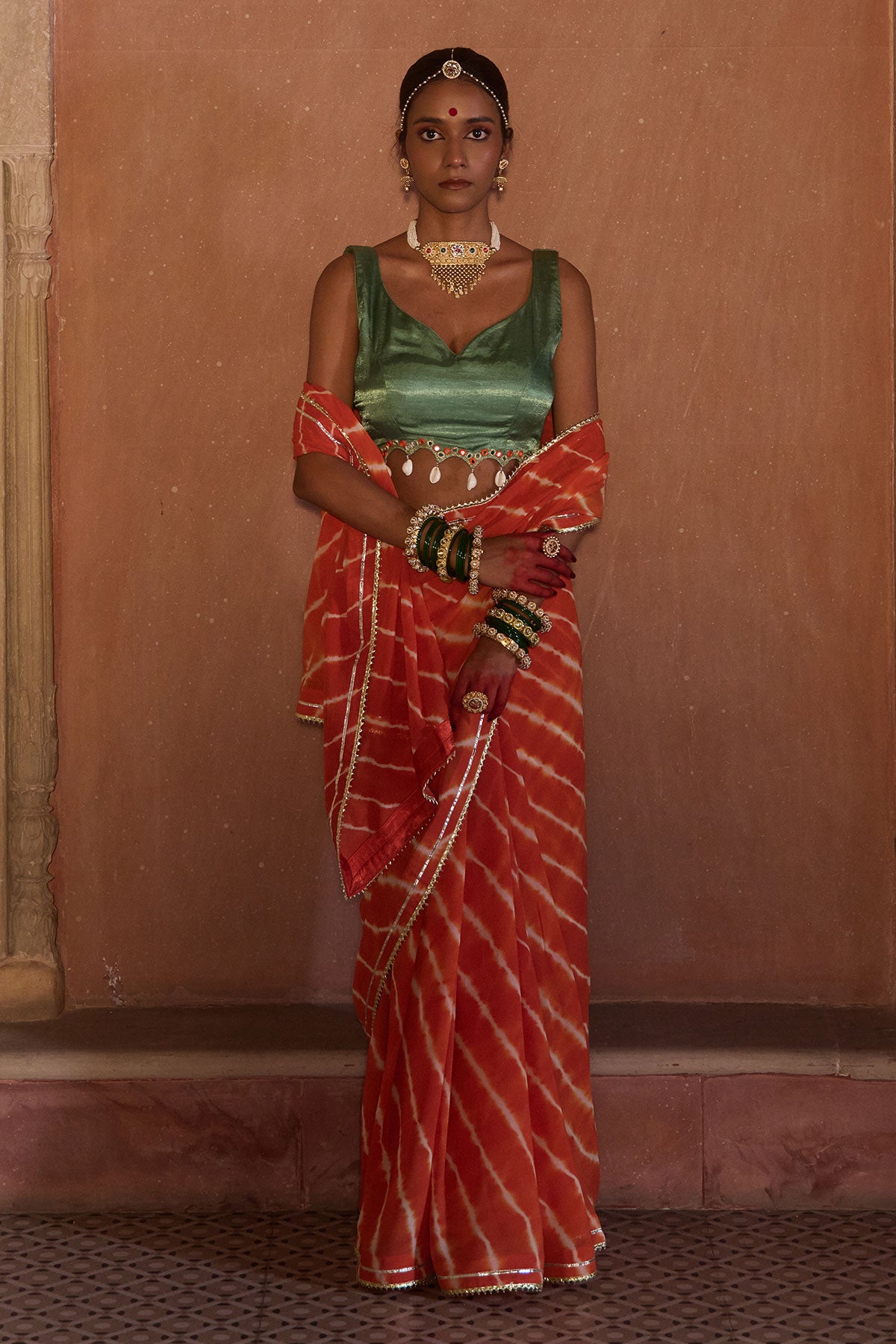 Palash – OrangeLeheriya Saree with Deep Sage Green Kaudi Blouse