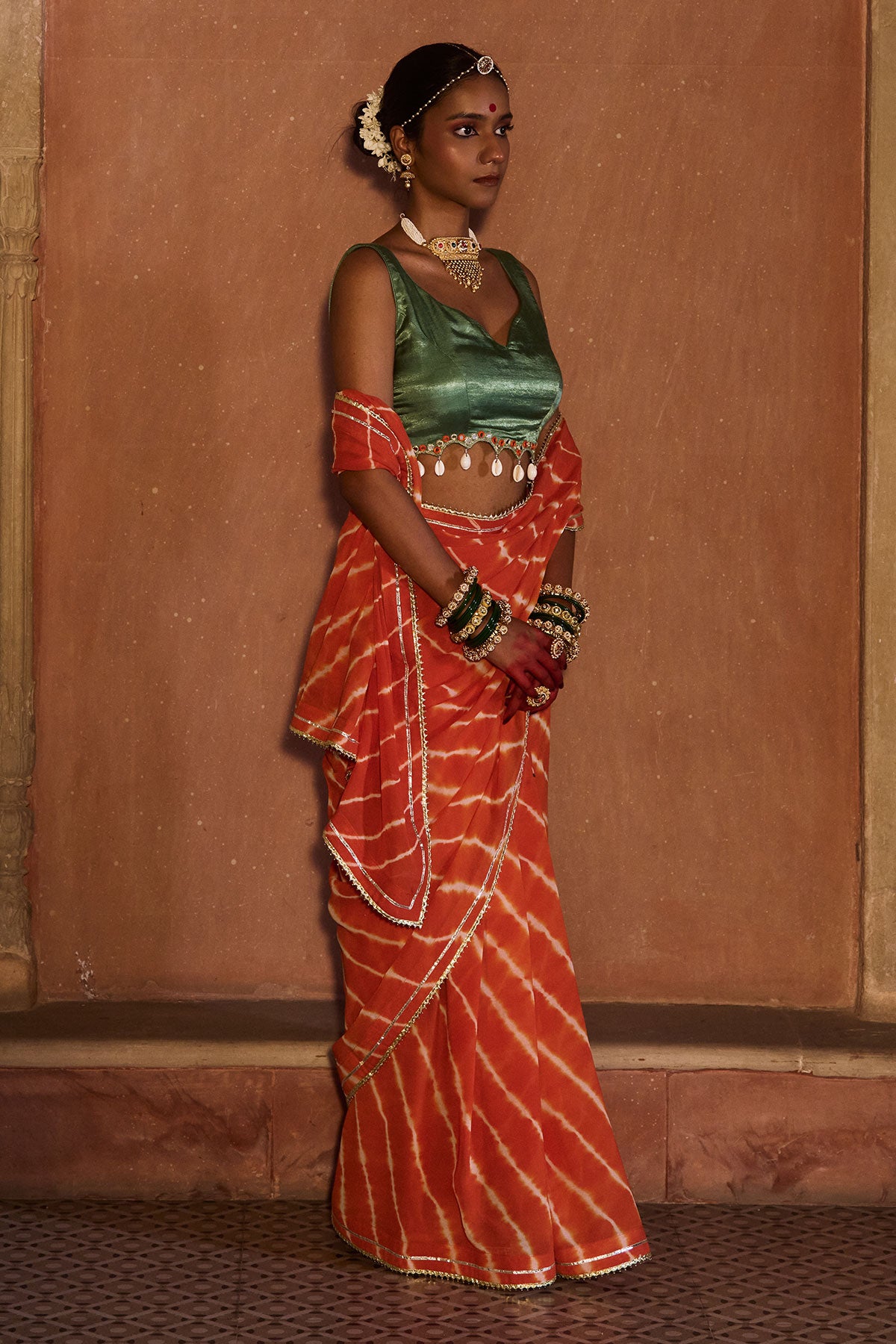 Palash – OrangeLeheriya Saree with Deep Sage Green Kaudi Blouse