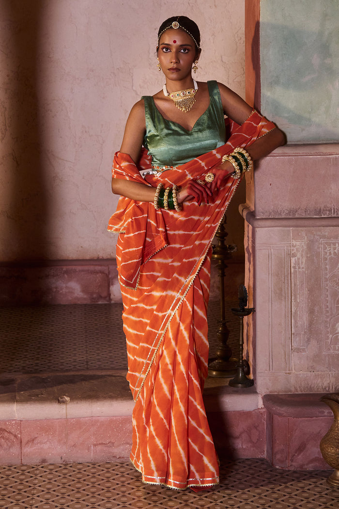 Palash – OrangeLeheriya Saree with Deep Sage Green Kaudi Blouse