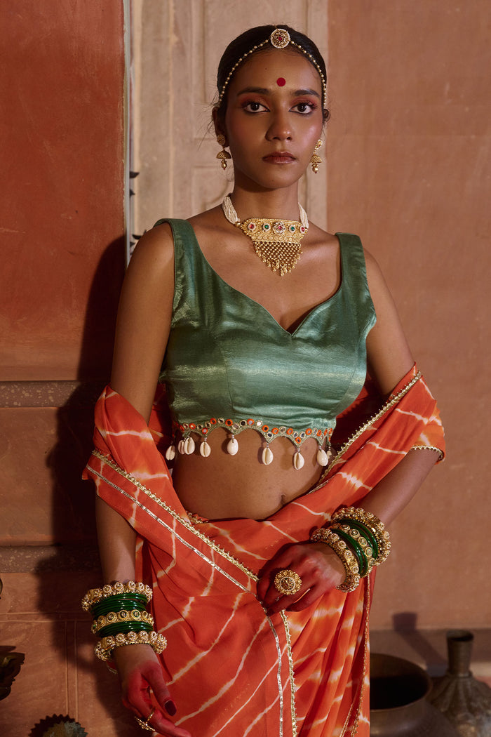 Palash – OrangeLeheriya Saree with Deep Sage Green Kaudi Blouse