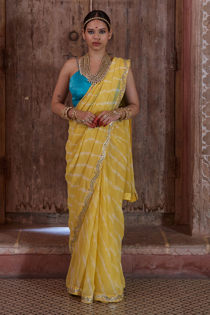 Surajmukhi – Ray Yellow Leheriya Saree with Blue Strings Blouse