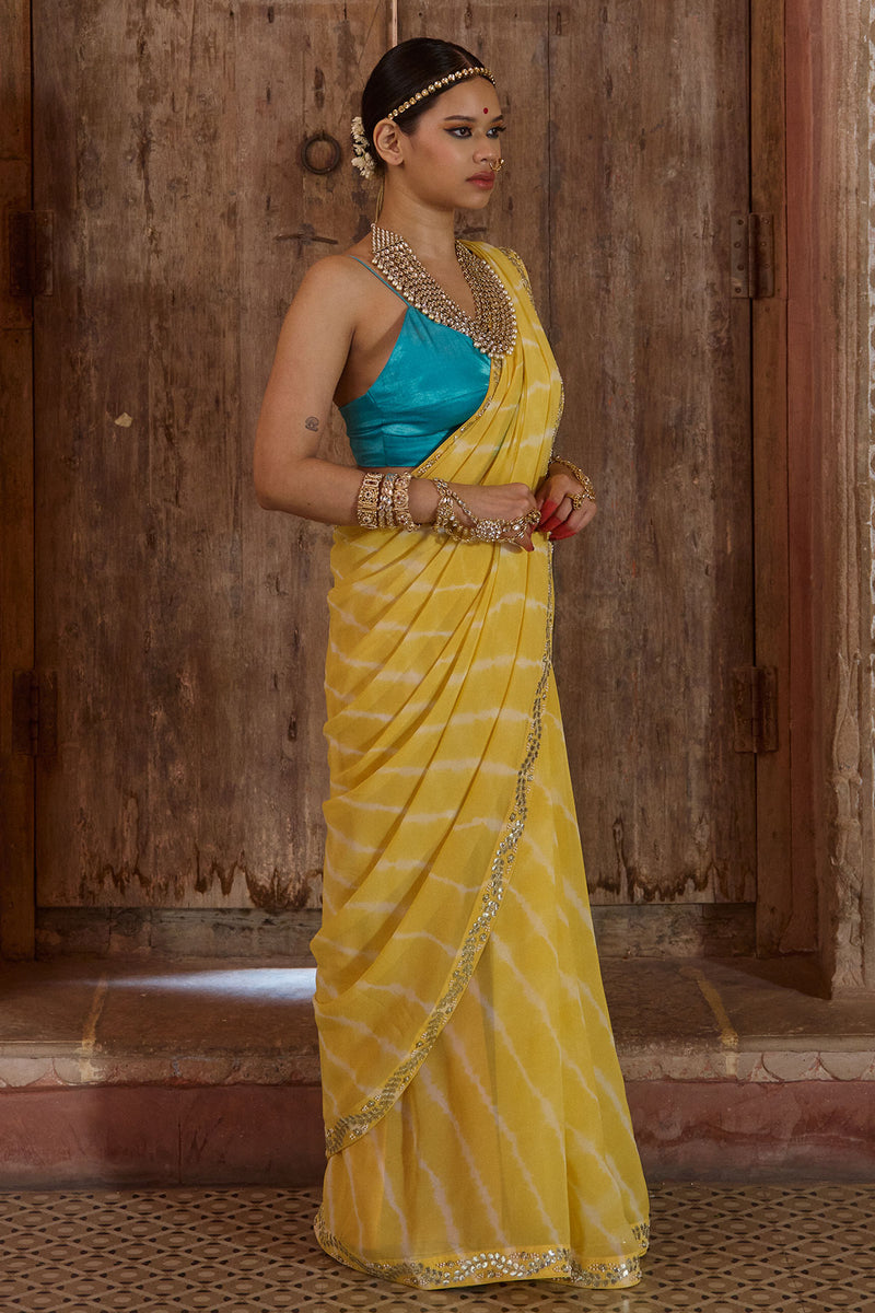 Surajmukhi – Ray Yellow Leheriya Saree with Blue Strings Blouse