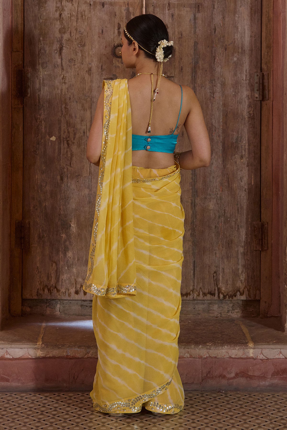 Surajmukhi – Ray Yellow Leheriya Saree with Blue Strings Blouse