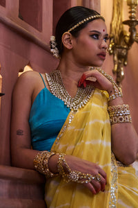 Surajmukhi – Ray Yellow Leheriya Saree with Blue Strings Blouse